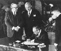 U.S. Secretary of State Dean Acheson signs the...